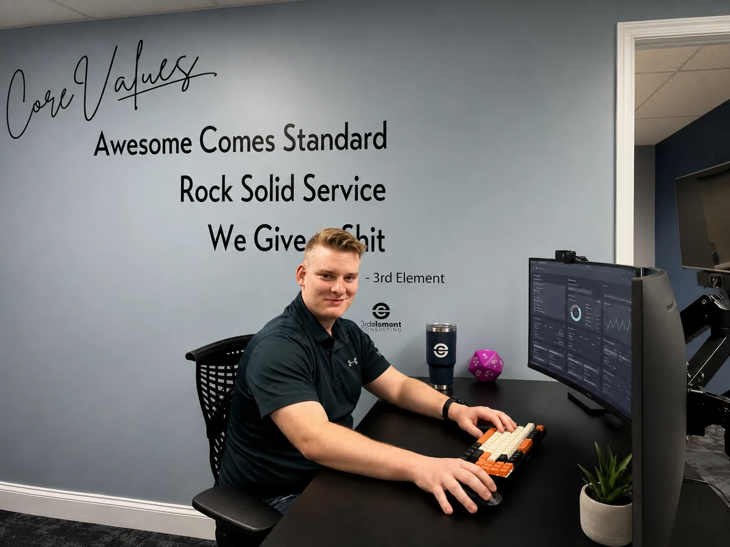 A 3rd Element technician working in front of the office's core values wall.